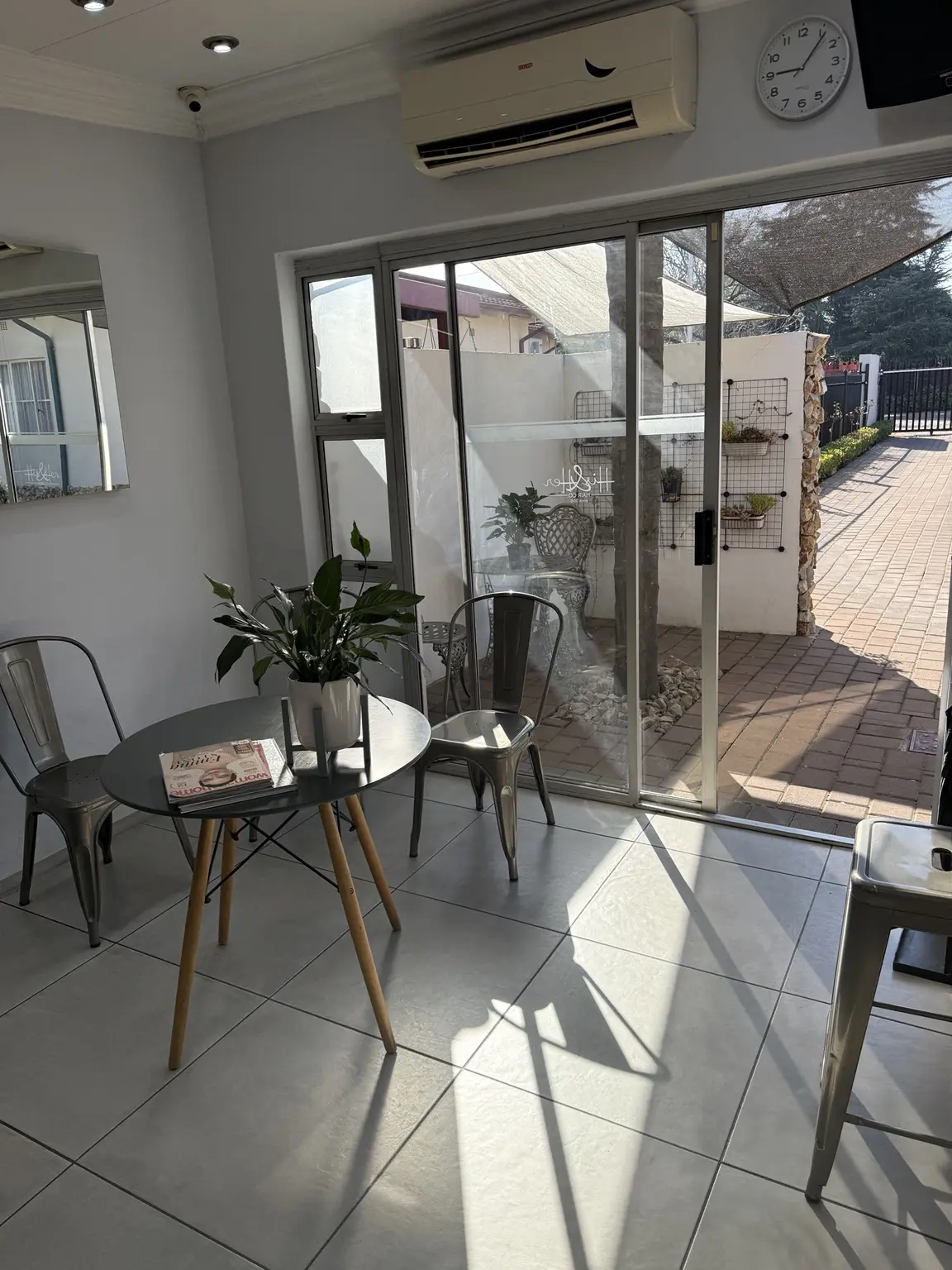 The sunlit waiting area at His & Her Hair Co