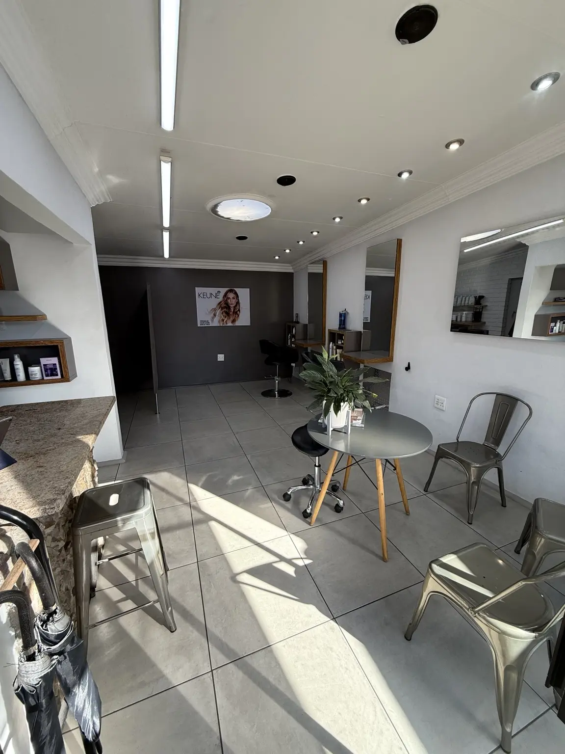 A wide view of the bright His & Her Hair Co salon